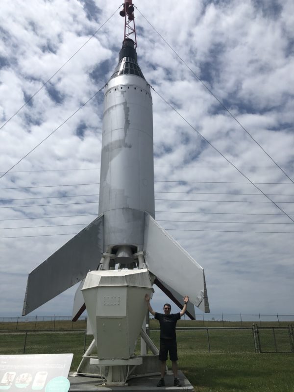 Standing under a mock up of the Little Joe rocket