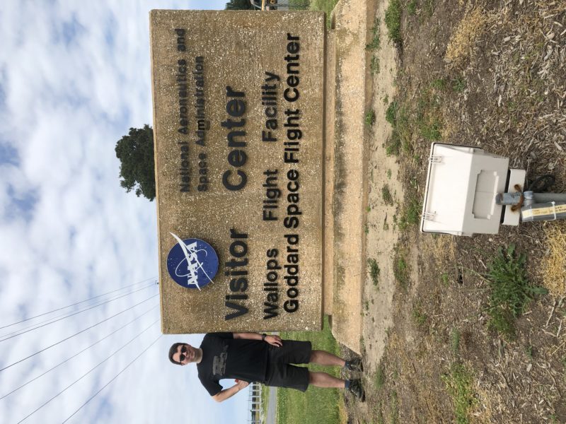 Standing by the NASA visitor center sign