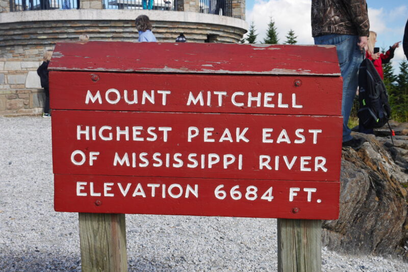 Sign reading "Mount Mitchell - Highest Peak East of the Mississippi River, Elevation 6684 ft"