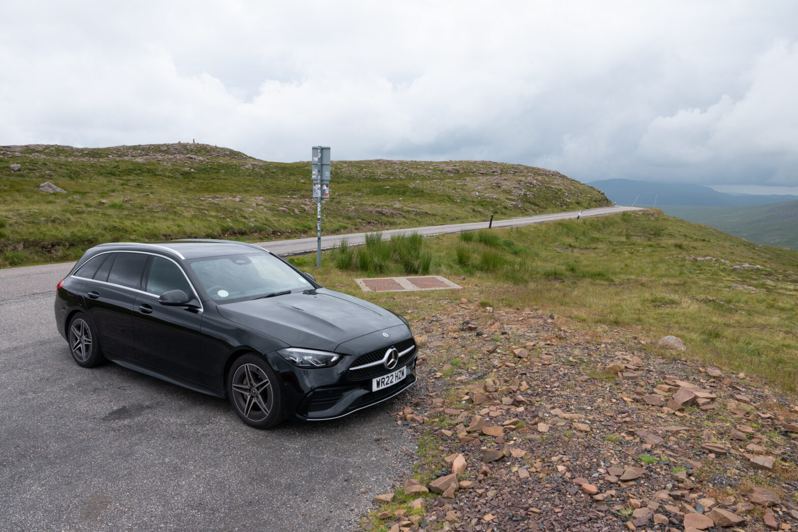 Our rental Mercedes C200 wagon parked alongside a road, high up in the Scottish highlands